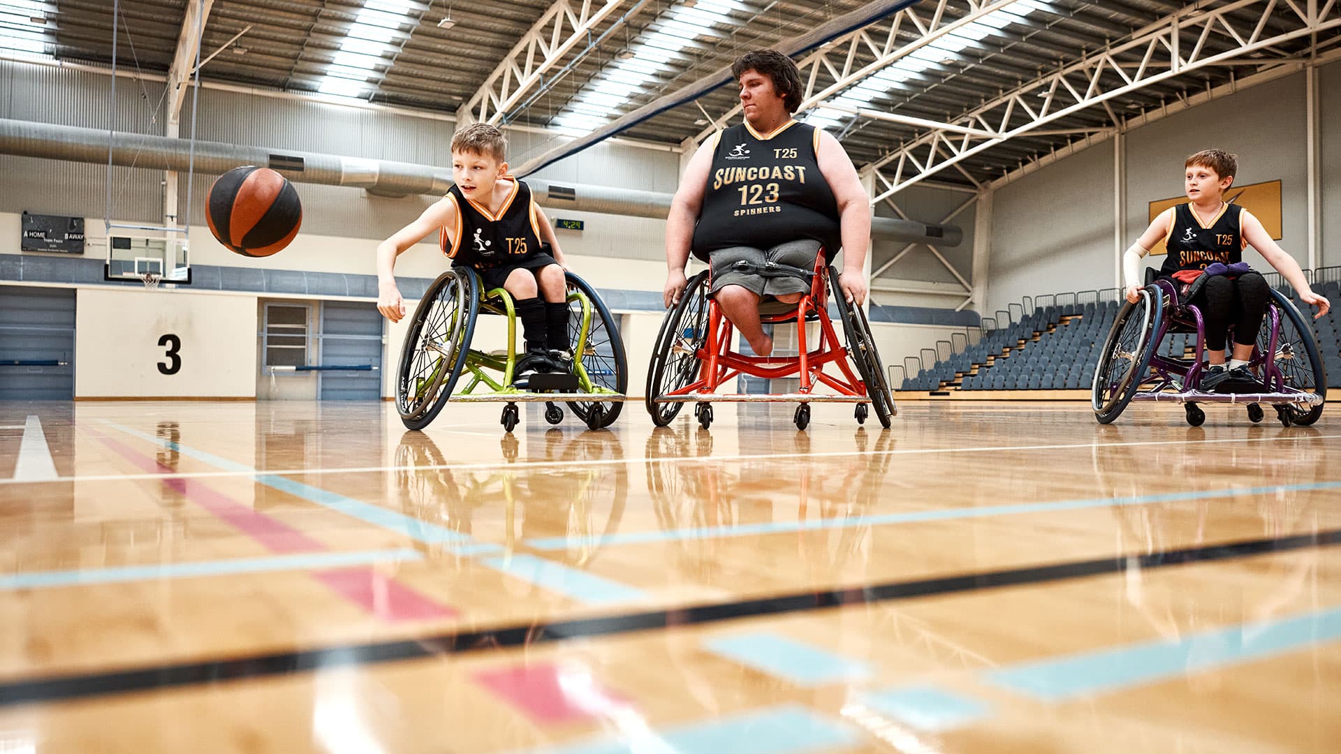Wheelchair basketball athletes at an Indoor Sports Centre