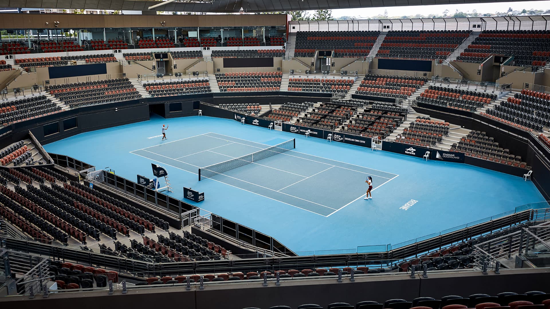 Two athletes rally on Pat Rafter Arena at the Queensland Tennis Centre