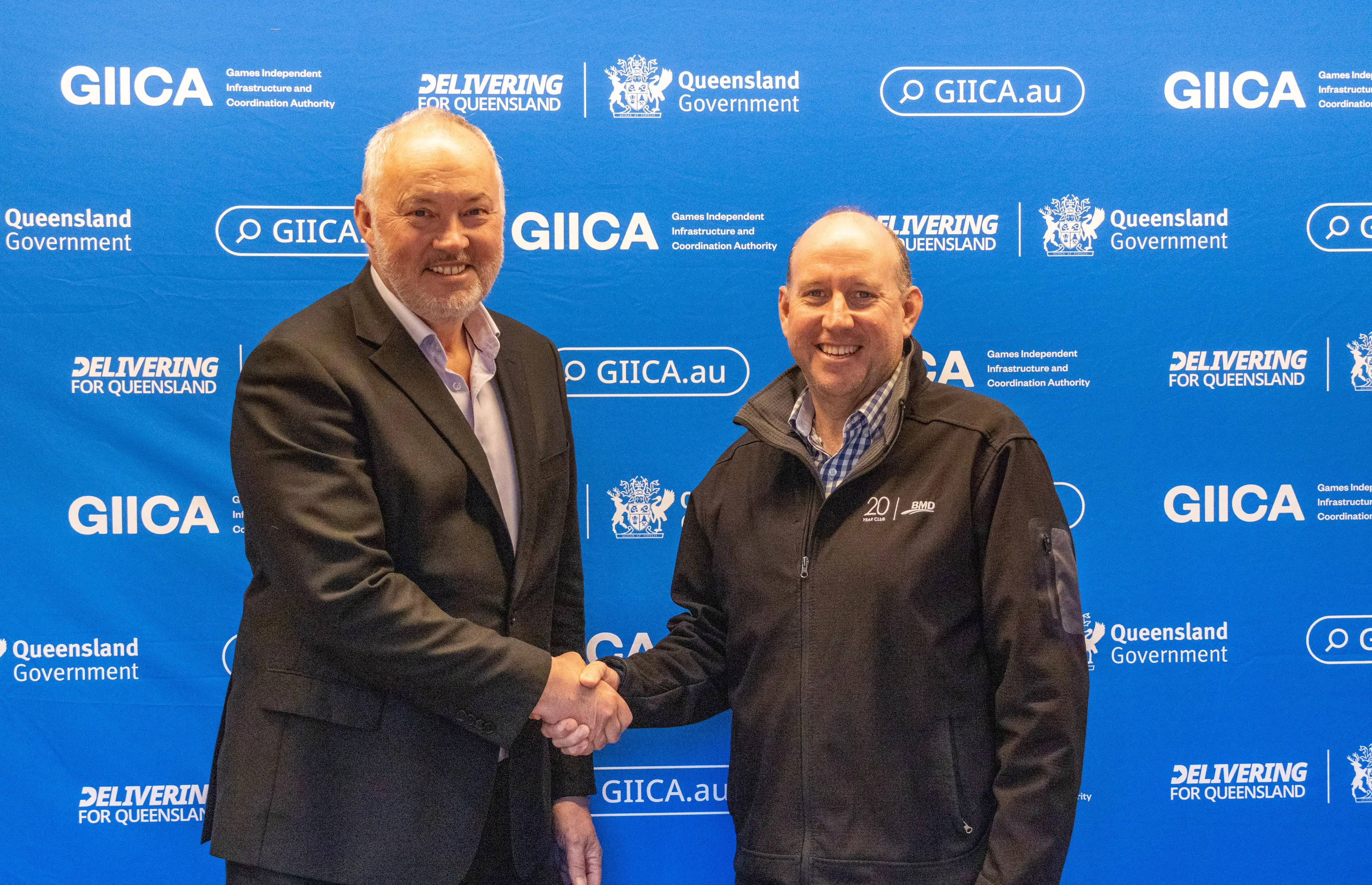 GIICA CEO Simon Crooks shakes hands with BMD CEO Scott Power