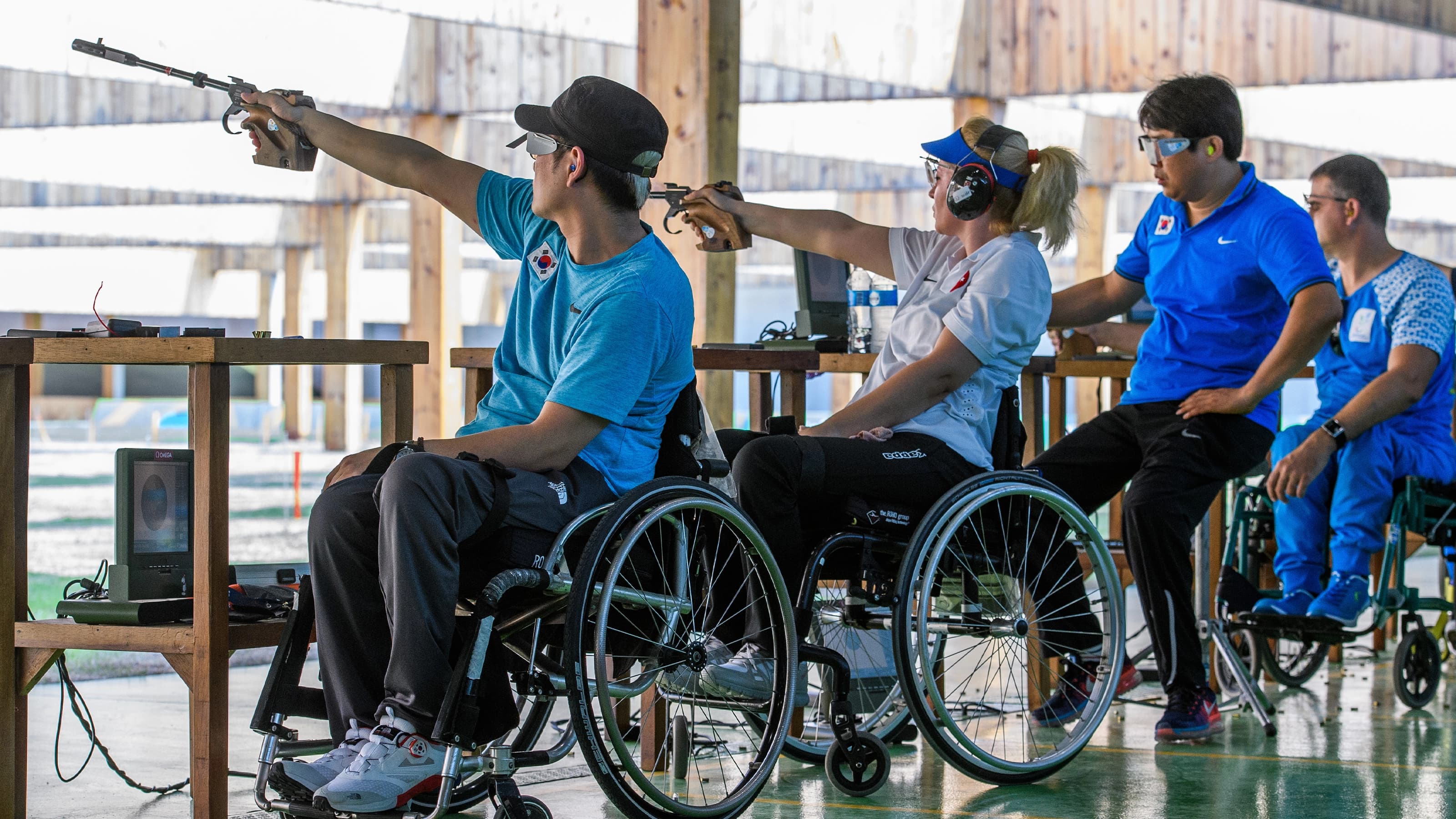 Para athletes lined up while competing in shooting